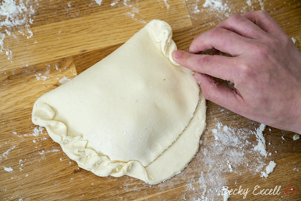 Pinch and fold the dough at the edges to form a nice, tight seal so that the filling doesn't leak out