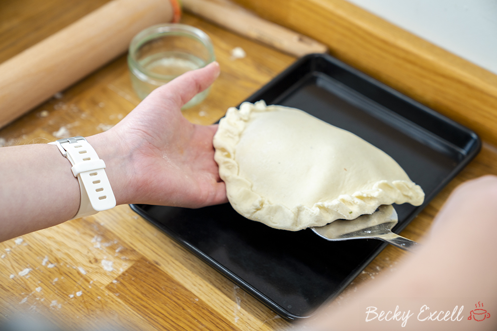 Gently place your gluten free calzone onto a non-stick baking tray
