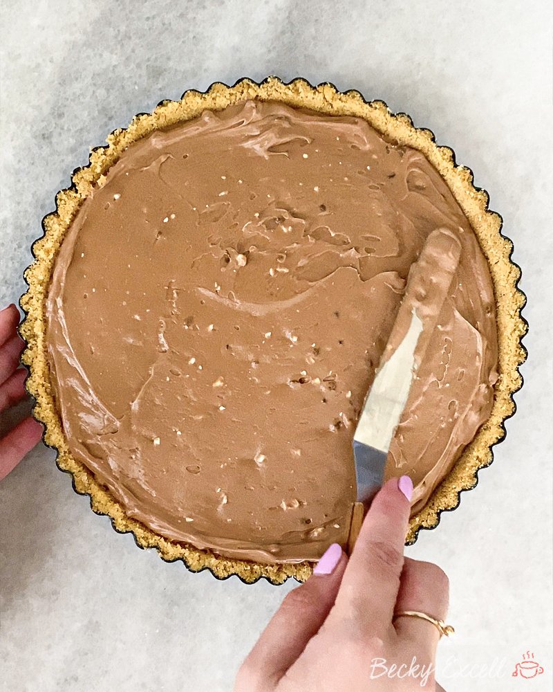 Gluten-free Chocolate Orange Toblerone Tart Recipe: Pour your Toblerone chocolate filling into the tart case and smooth until even.