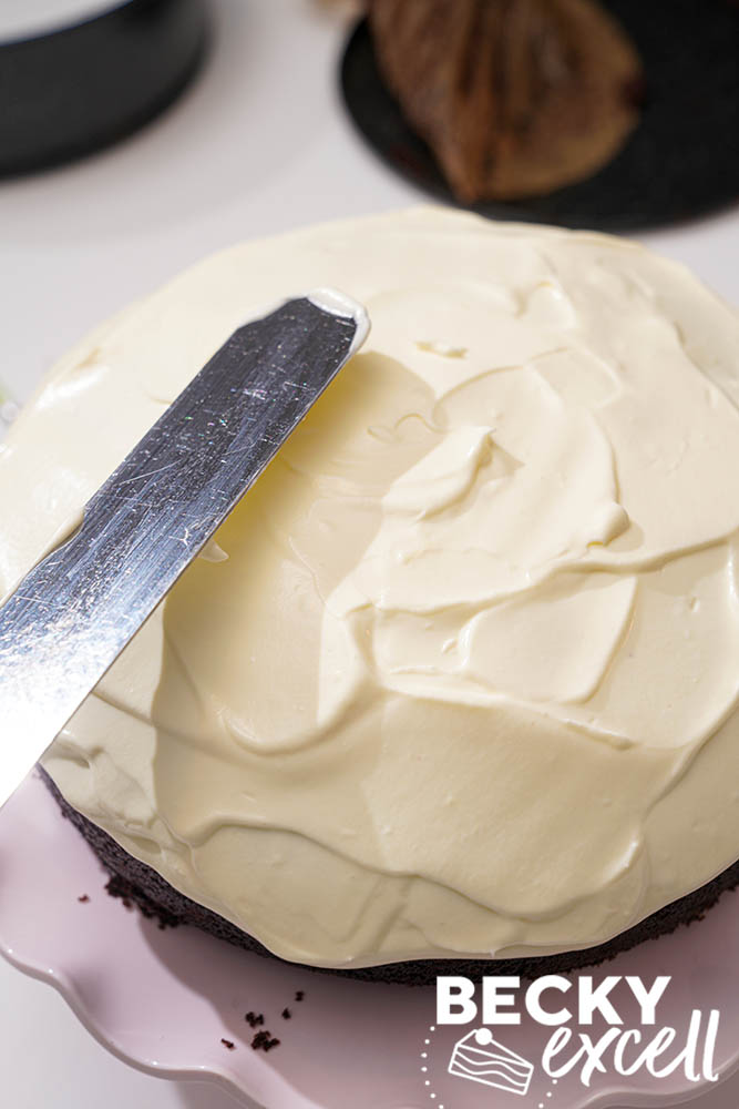 Applying the cream cheese frosting