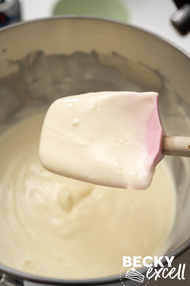 The consistency of the finished cheesecake filling after the sour cream has been folded in by hand
