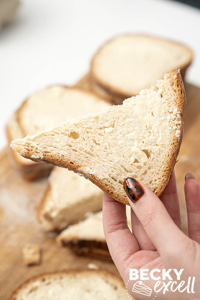 A triangle of buttered gluten-free bread