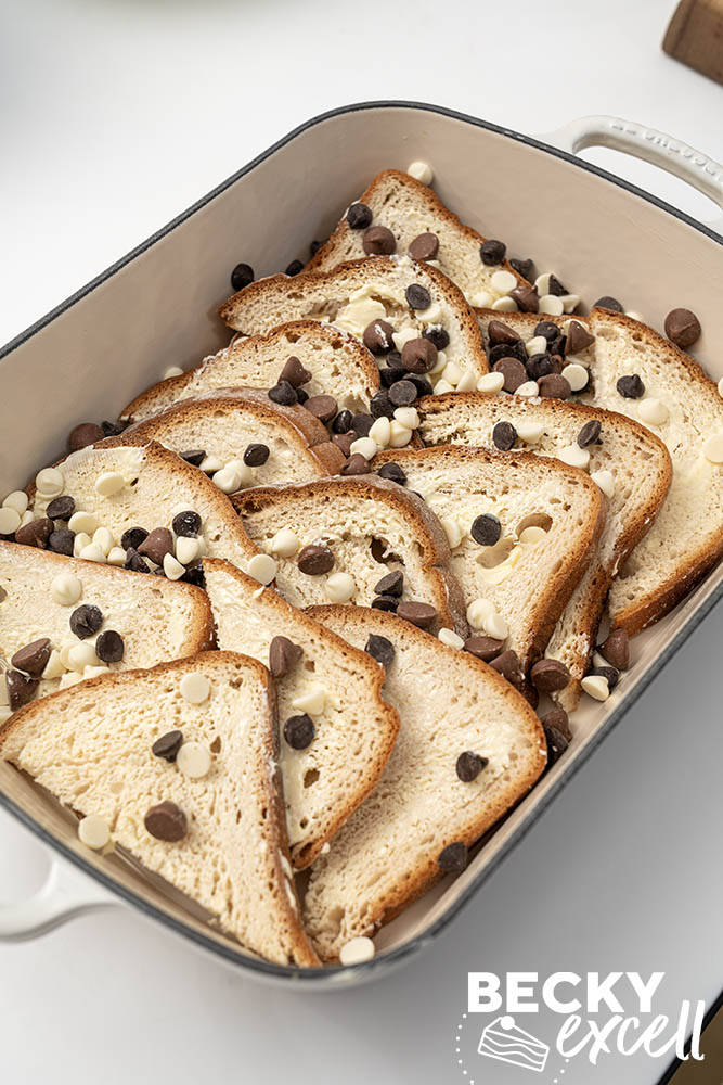 The first layer of bread slices arranged with the chosen topping scattered on