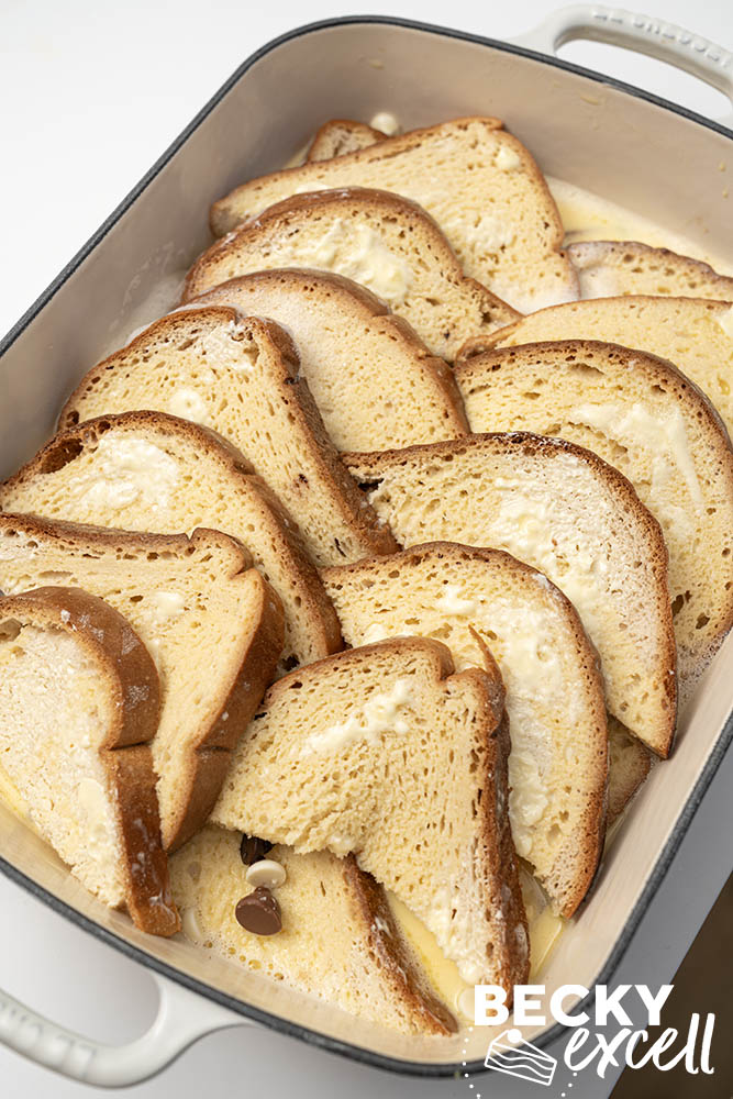 The gluten-free bread triangles arranged and custard mixture poured on top prior to allowing to rest