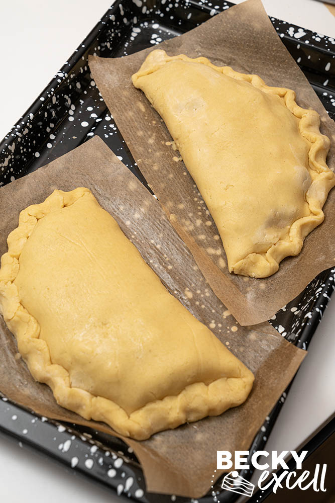 Use the paper to lift them onto the tray to reduce handling of the fragile pastry
