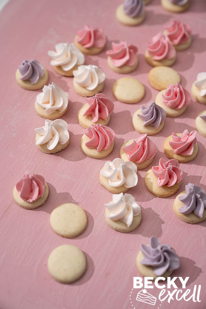 finished gluten-free iced gems in three colours: purple (blackcurrant flavour), pink (raspberry flavour) and white (vanilla)