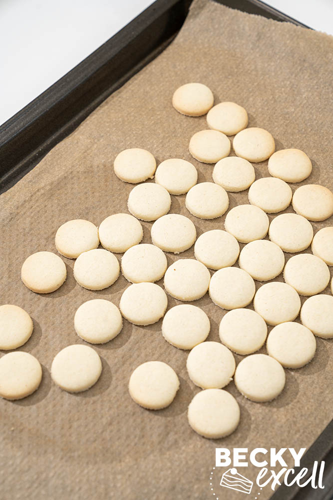 mini 2cm gluten-free vanilla biscuits freshly baked and out of the oven, ready for icing once cooled